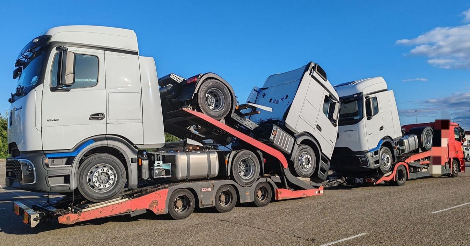 Several trucks loaded on a vehicle transport trailer